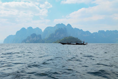 Boat sailing in sea against sky