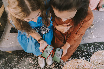 High angle view of girl using mobile phone