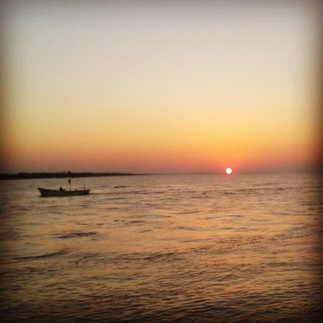 sunset, sea, water, nautical vessel, horizon over water, waterfront, transportation, sun, boat, scenics, tranquil scene, orange color, mode of transport, beauty in nature, tranquility, copy space, clear sky, nature, idyllic, rippled