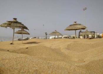 Close-up of sand on beach against clear sky