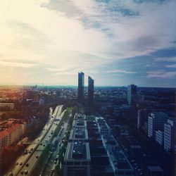 Cityscape against cloudy sky