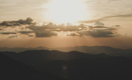 Scenic view of silhouette mountains against sky at sunset