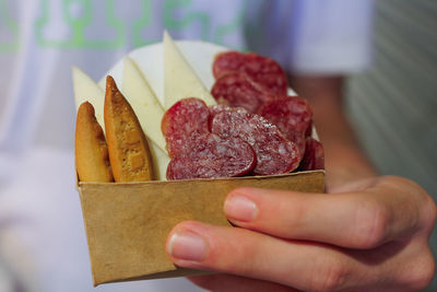 Cropped hand of person holding food