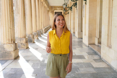 Young smiling student girl doing cultural tourism in europe