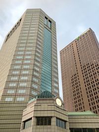 Low angle view of modern buildings against sky in city