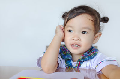 Cute smiling girl against white background