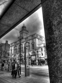 Buildings in city against cloudy sky