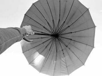 Low angle view of woman holding umbrella