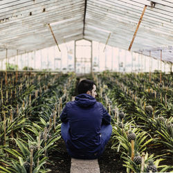 Rear view of woman standing in field