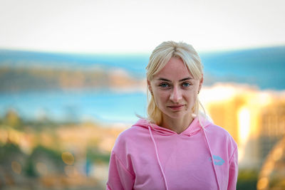 Portrait of woman standing against sea