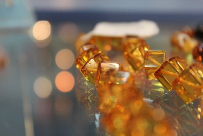 Close-up of orange beads on table