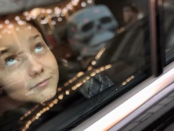 Portrait of man seen through car window