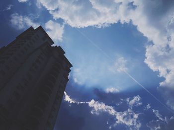 Low angle view of building against cloudy sky