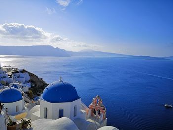 Panoramic view of sea and buildings against sky