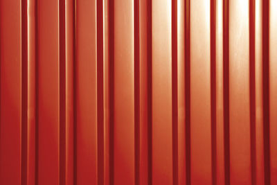 Red sheet metal profile, background. outdoors of day. front view.