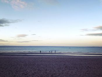 Scenic view of beach against sky during sunset