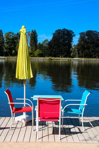 Chairs and table on terrace  against blue sky