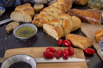 Feast, messy table. bread in the shape of a braid. sweet challah. breakfast, side view. cherry