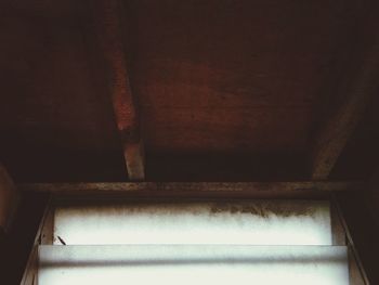 Low angle view of window in abandoned house