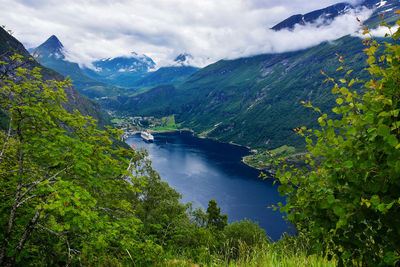 Scenic view of river amidst mountains against sky