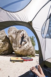 Young man bouldering in the forest of fontainebleau close to paris