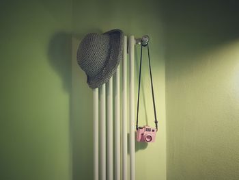 Close-up of hat hanging on wall