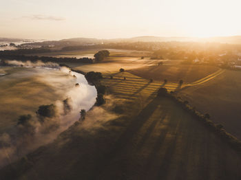 Aerial view of landscape against sky during sunset