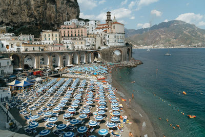 High angle view of buildings by mountain against sky