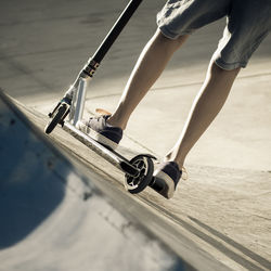 Low section of woman skateboarding on street