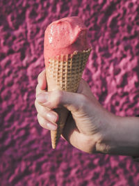 Close-up of woman holding pink flower