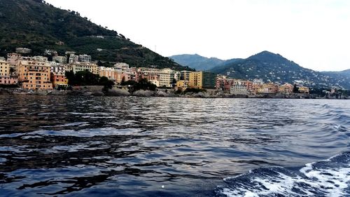 Town by sea against clear sky