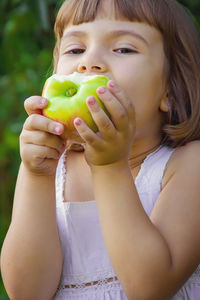 Close-up of woman holding orange fruit