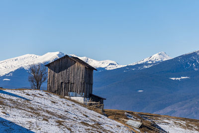 Scenic view of snowcapped mountains against clear sky