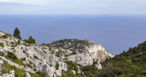 Scenic view of sea and mountains against sky