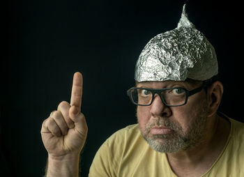 Strange man in a foil cap on his head. conspirology concept