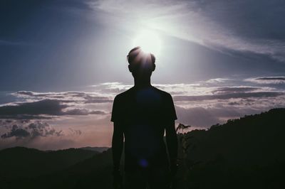 Silhouette of man standing on mountain