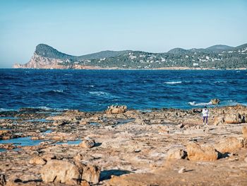 Scenic view of sea with rocks in background