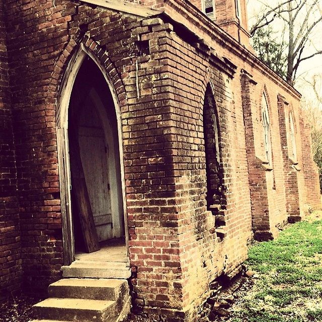 architecture, built structure, building exterior, window, old, arch, stone wall, brick wall, history, door, house, building, facade, day, entrance, tree, outdoors, no people, low angle view, abandoned