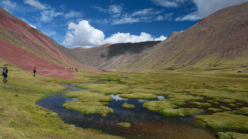 Scenic view of field and mountains against sky