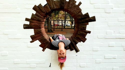 Full length of woman dancing against wall