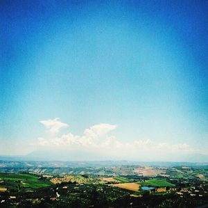 Scenic view of landscape against blue sky