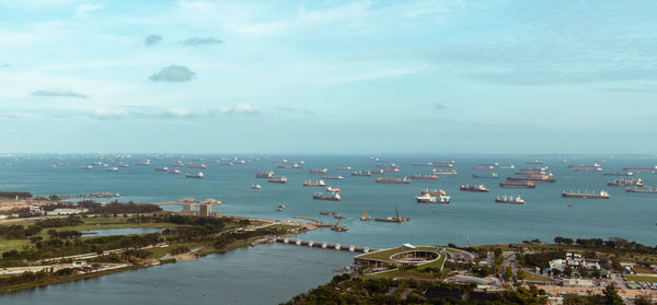 High angle view of sea by buildings against sky