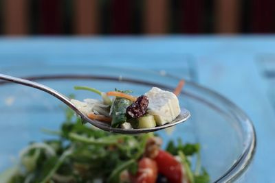 Close-up of salad on spoon on table