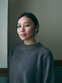 Portrait of young woman at home