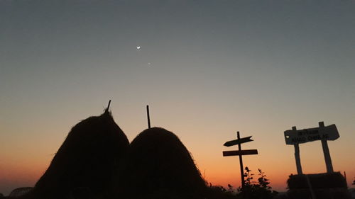 Silhouette people against clear sky during sunset