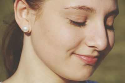 Close-up of beautiful smiling woman wearing earring