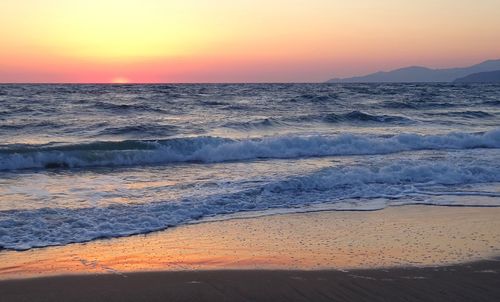 Scenic view of beach against sky during sunset