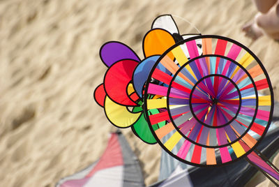 High angle view of colorful pinwheel toy at beach