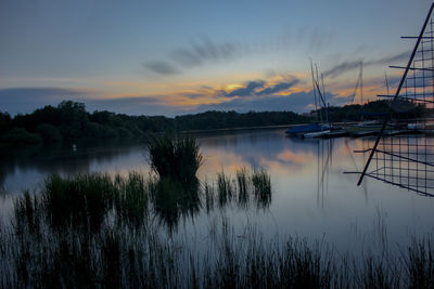 Scenic view of lake against sky at sunset