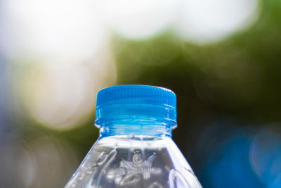 Close-up of cropped water bottle against blurred background